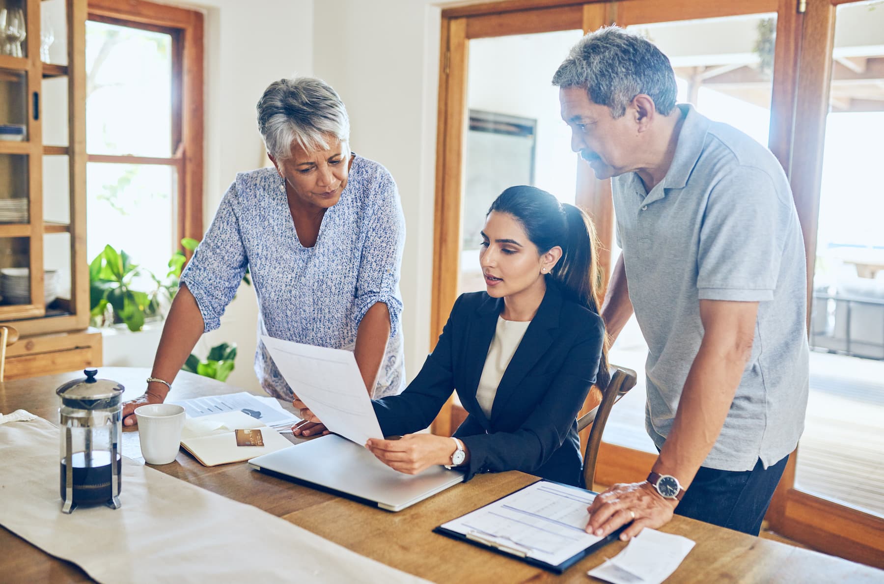 Couple reviewing documents with mediator during family financial mediation session